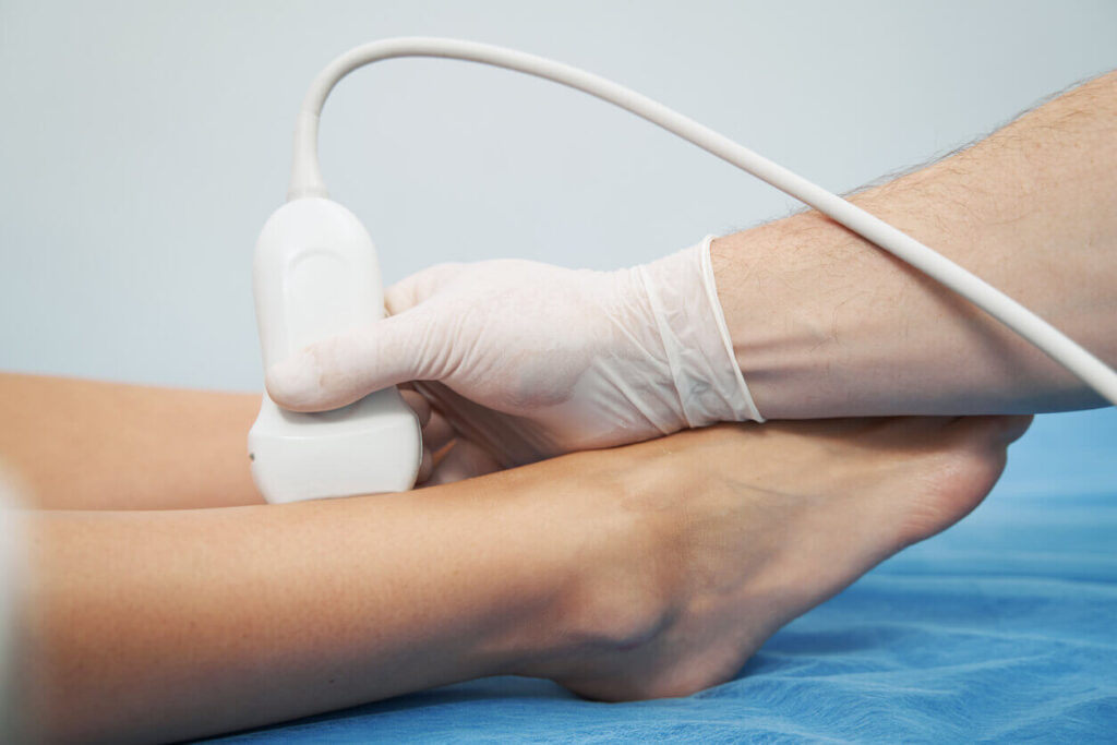 image showing a healthcare professional performing a vein health screening using ultrasound technology on a patient.