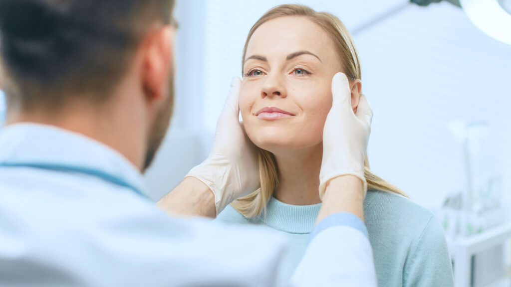 A close-up of a cosmetic specialist examining the face for Botox and fillers.