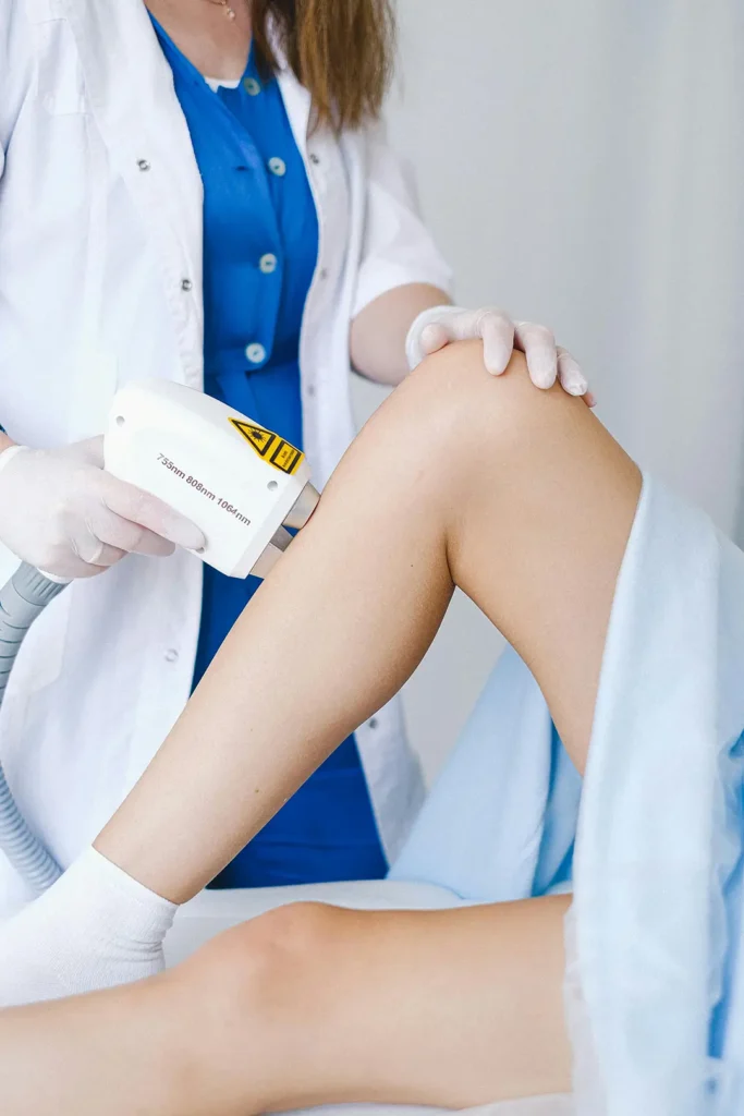 A patient is getting the leg veins examined by a doctor